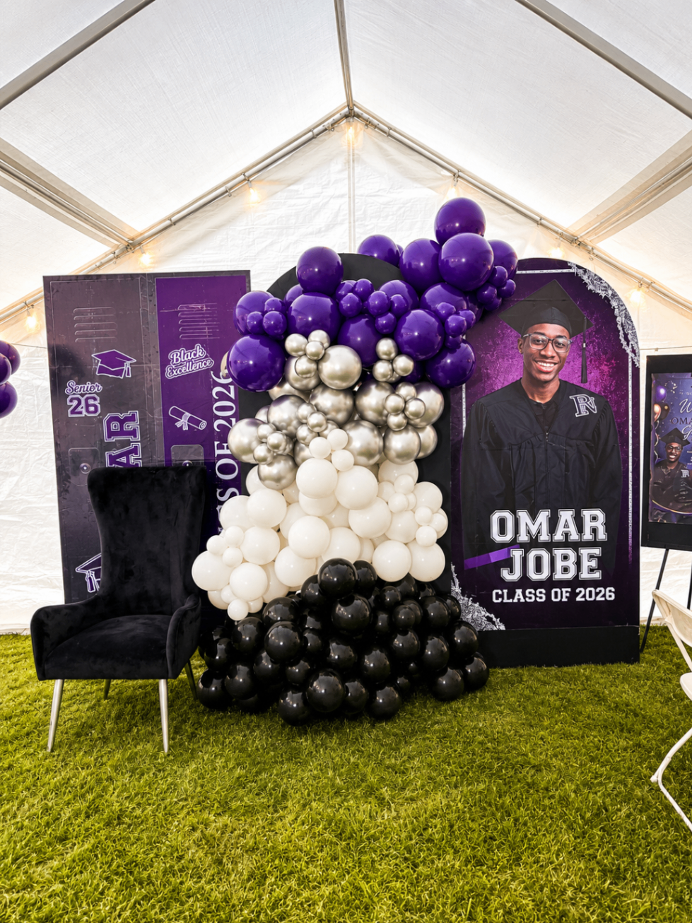 Purple graduation event vignette with balloons, chair, and custom portrait display.