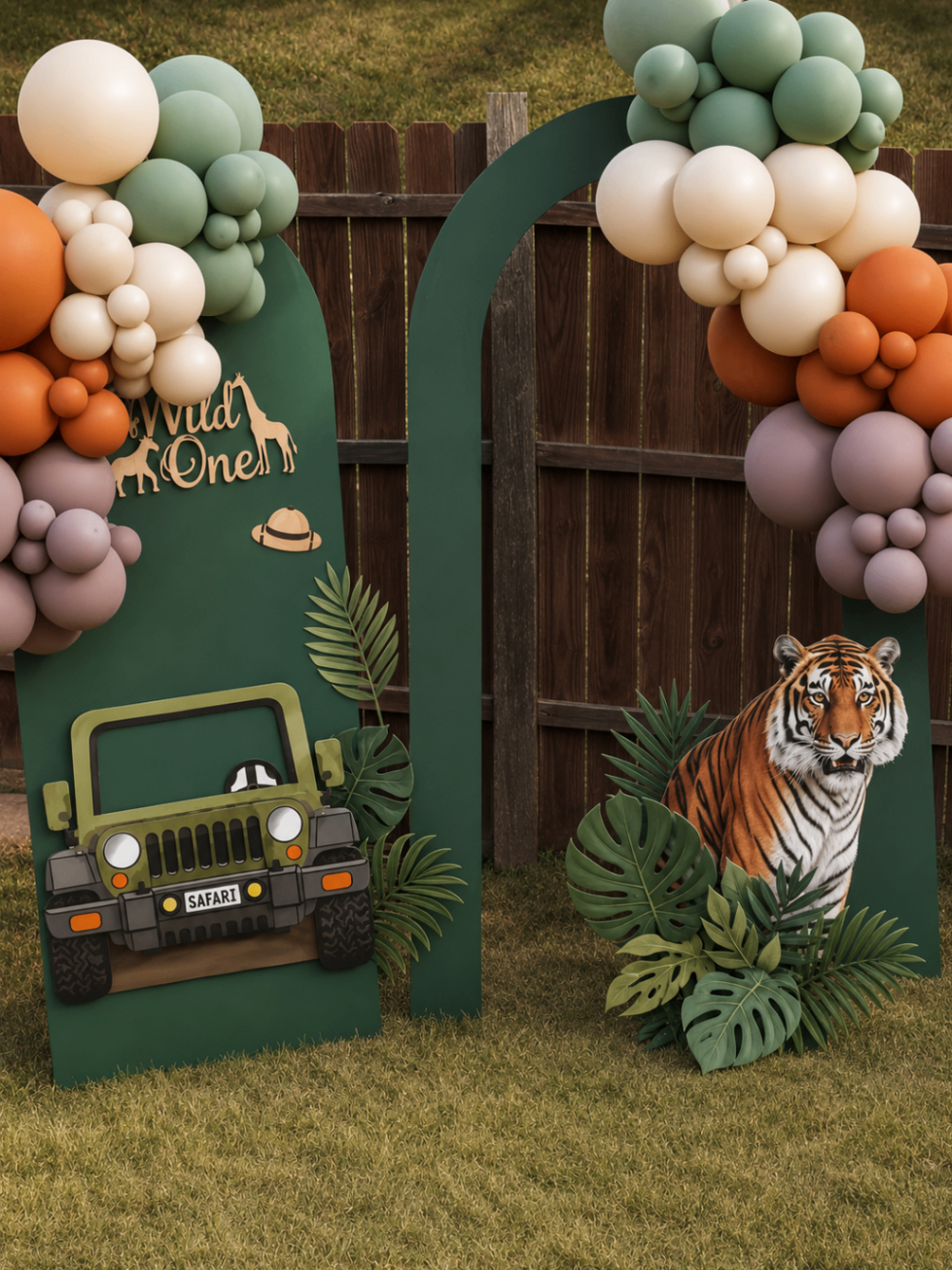 Safari themed children's event display with balloons, jeep prop, and tiger cutout.